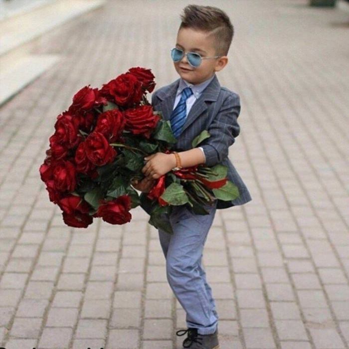 Маленький мальчик с букетом роз